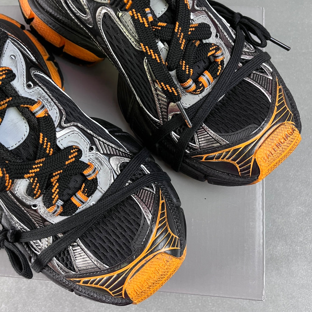Balenciaga unisex chunky sneakers, side view with black mesh, silver panels, orange trim