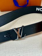 Louis Vuitton belt close-up: dark blue textured band with gold-tone buckle and clasp.