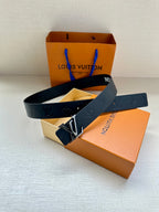 Louis Vuitton belt in dark blue with embossed monogram, gold-tone buckle, and blue loop tag.