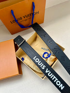 Louis Vuitton belt flat lay: dark blue embossed monogram strap with gold-tone LV buckle.
