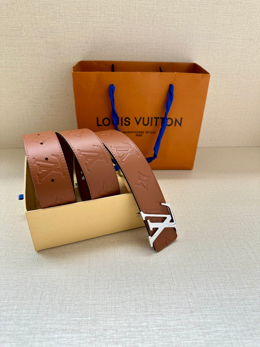 Louis Vuitton leather belt with brown embossed strap and silver-tone LV buckle in box