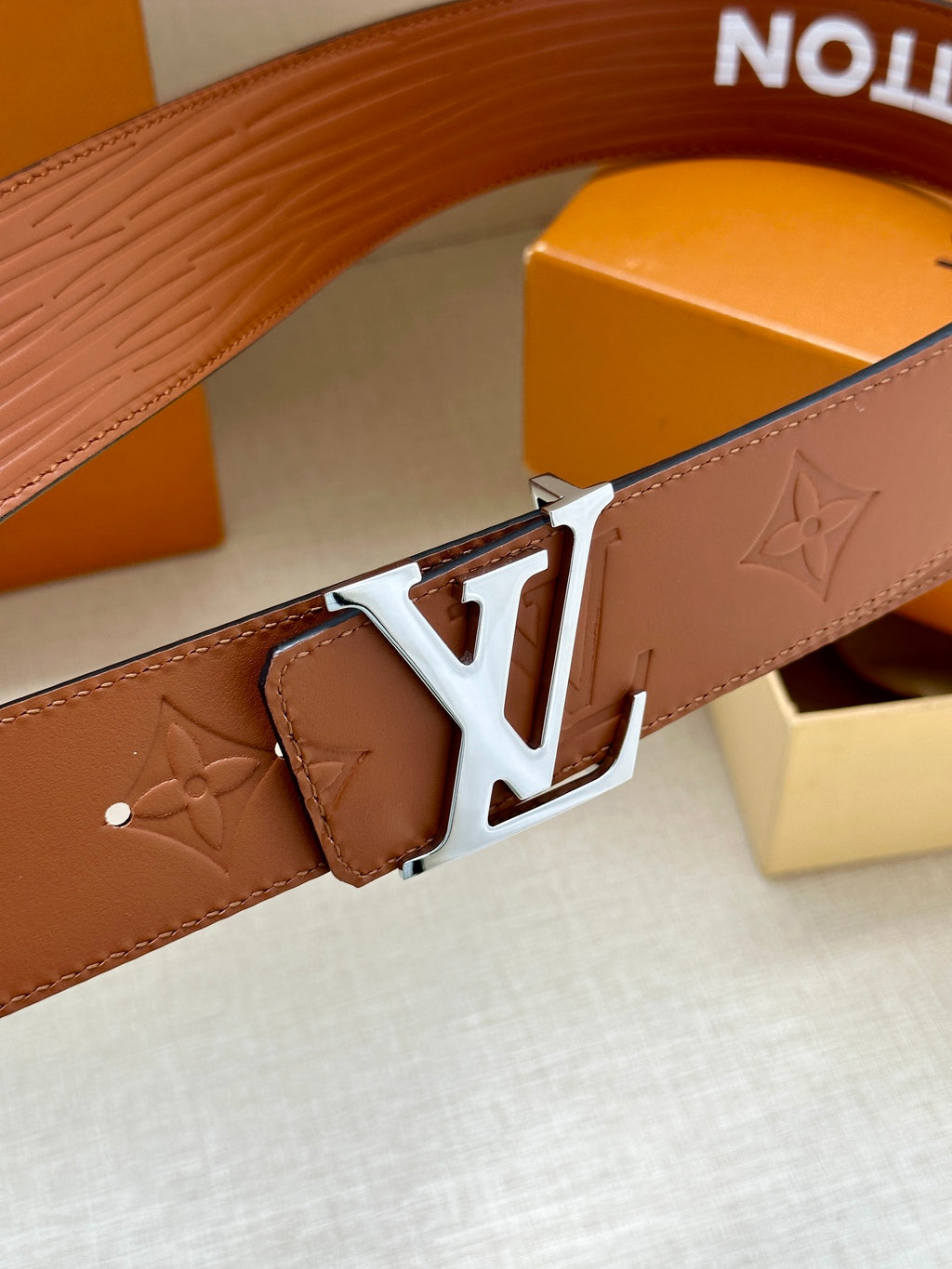 Louis Vuitton brown belt detail with embossed monogram leather and silver-tone buckle