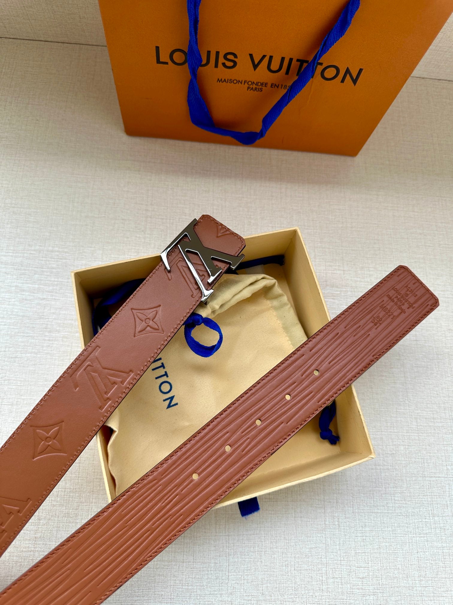 Louis Vuitton brown belt with embossed monogram and silver-tone buckle in box