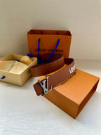 Louis Vuitton belt in brown with embossed texture and silver-tone LV buckle on box