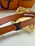 Monogram leather belt close-up with embossed pattern and dark LV buckle