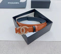 Chanel belt: dark strap, tan body, ornate gold-tone CC buckle with stars