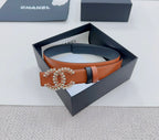 Chanel belt: dark strap, tan body, ornate gold-tone CC buckle with stars