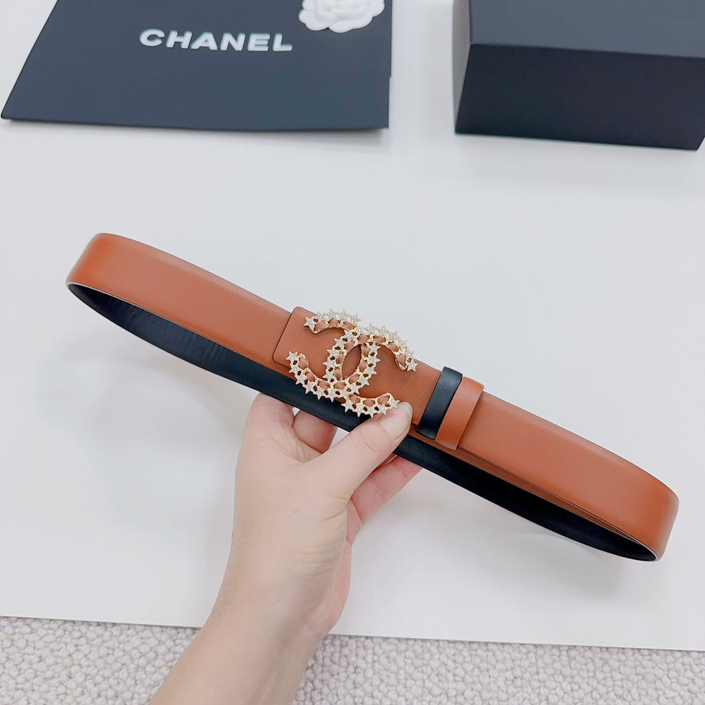 Chanel belt laid out: tan body and dark strap with embellished gold-tone CC buckle