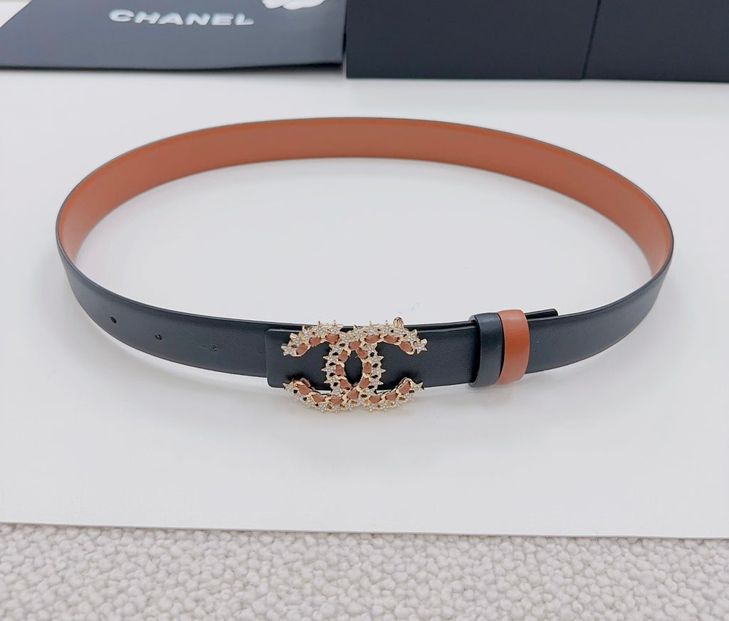 Chanel belt on display: tan band and dark strap with gold-tone CC buckle emblem