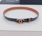 Chanel belt on display: tan band and dark strap with gold-tone CC buckle emblem