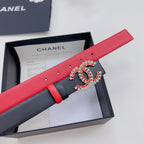 Red leather belt with black inlay and jeweled logo buckle, pin-hole row