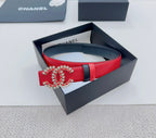Chanel leather belt with red strap, black trim, and jeweled logo buckle