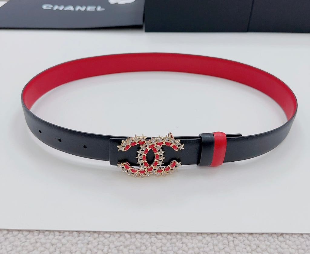 Red and black leather belt with jeweled logo buckle and pin-hole strap
