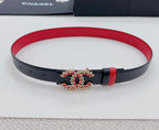 Red and black leather belt with jeweled logo buckle and pin-hole strap
