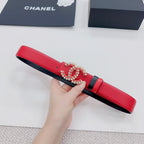 Red leather belt with black ends and jeweled decorative logo buckle