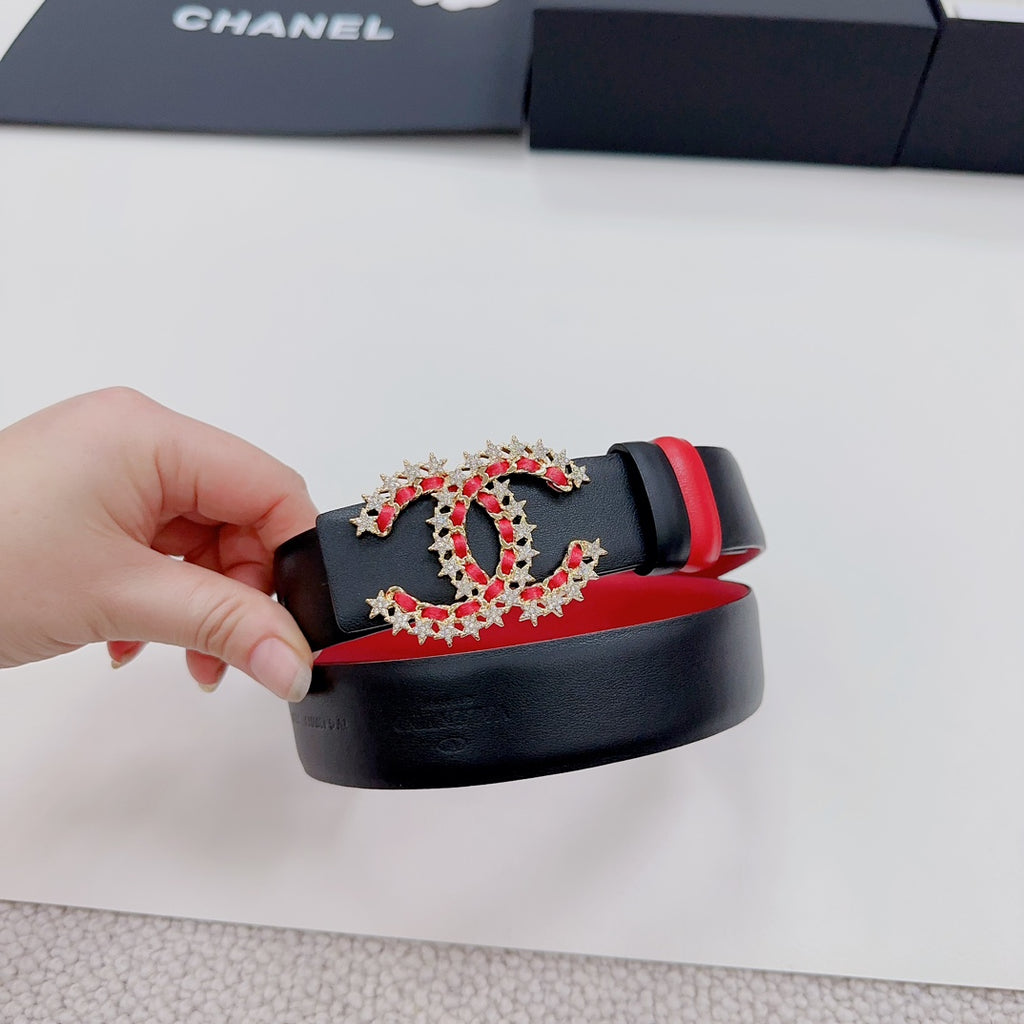 Red-and-black leather belt with jeweled logo buckle and black keeper