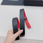 Black leather belt with red strap and jeweled logo buckle, side view