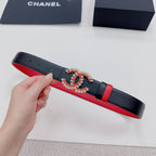 Black leather belt with red underside and jeweled logo buckle