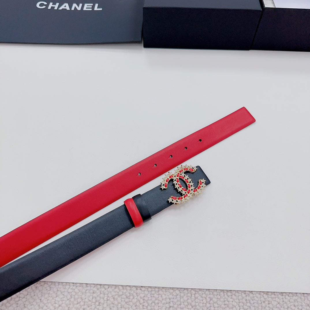 Red leather belt with black panel and jeweled logo buckle, length view