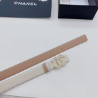 Beige leather belt with gold-tone jeweled buckle detail and metal grommet holes.
