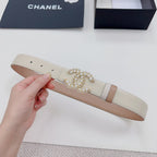 Beige leather belt with gold-tone embellished buckle and light leather keeper strap.