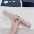 Chanel belt light beige, front view with gold buckle and black stone emblem.