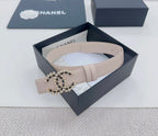 Chanel belt, light beige, gold buckle with black stone logo embellishment.