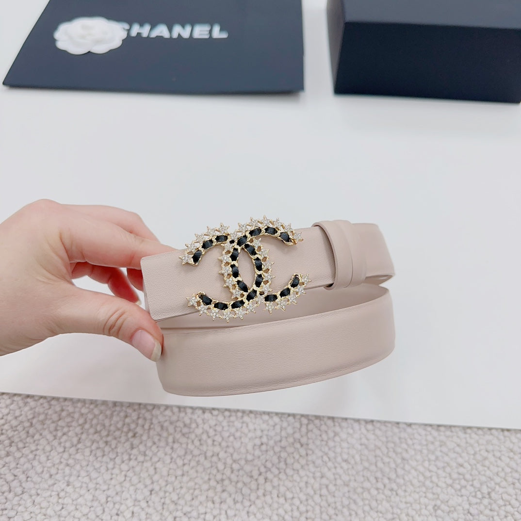 Chanel belt light beige with gold buckle shaped logo, set with black stones.