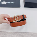Orange leather belt with floral filigree buckle and dark leather keeper strap