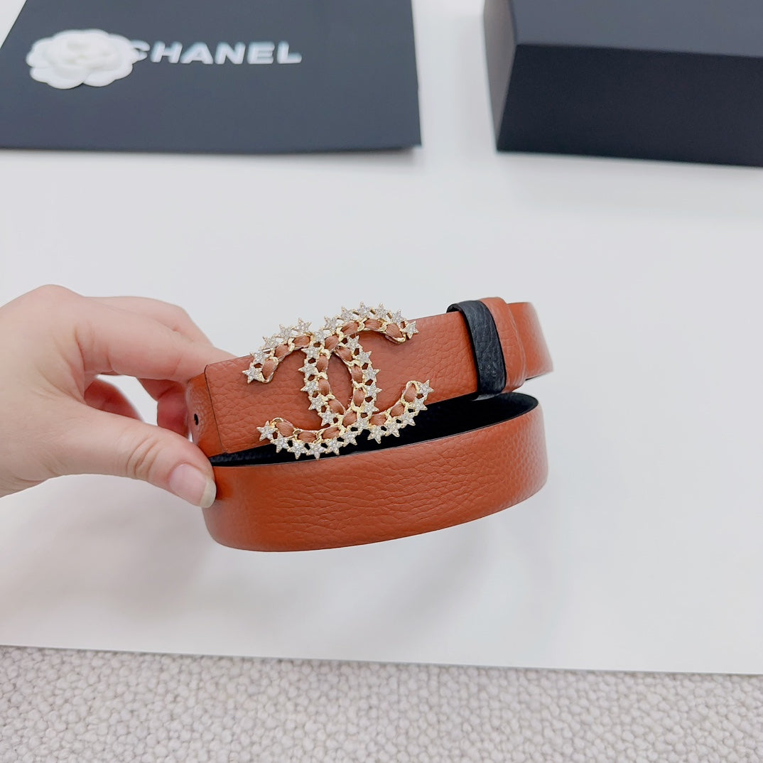 Orange leather belt with floral filigree buckle and dark leather keeper strap