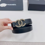 Navy leather belt with gold-tone logo buckle, held up for close-up view