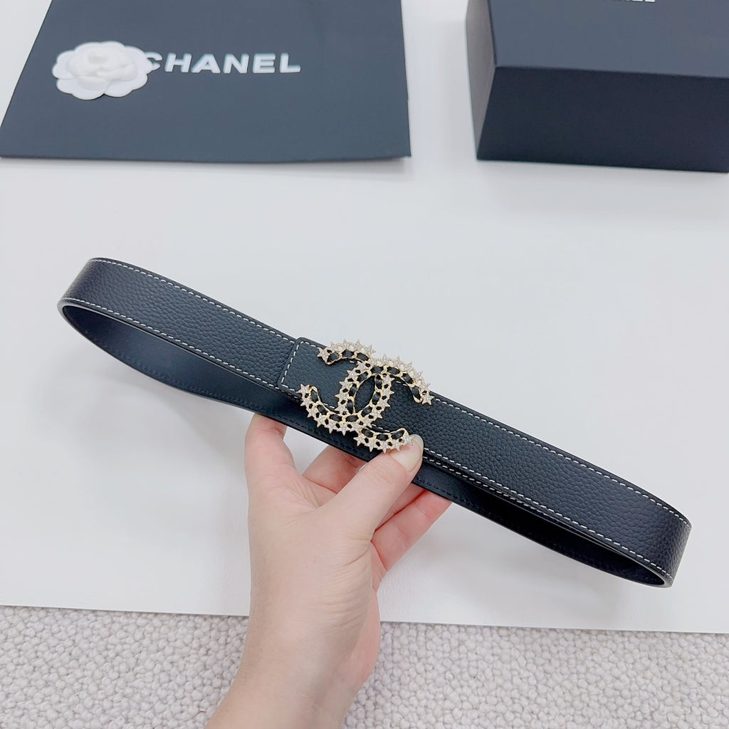 Navy leather belt with gold-tone logo buckle, end view showing strap stitching