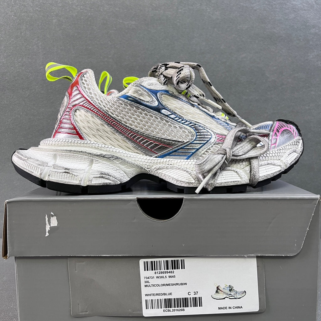 Unisex sneakers on box, white uppers with blue stripes, red trim and neon green laces