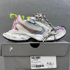 Unisex sneakers on box, white uppers with blue stripes, red trim and neon green laces
