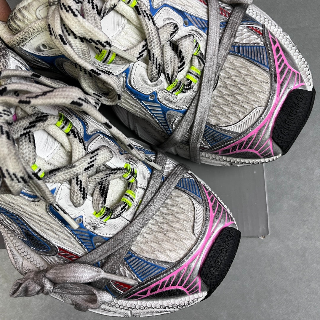 Unisex sneakers close-up, white mesh uppers with blue accents, pink trim, neon green lace tips