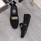 Versace black textured loafers with gold buckle and teal-trim side accents