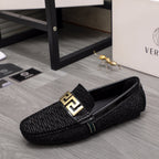 Versace black textured loafers with gold square emblem buckle and slip-on design