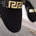 Versace black textured loafer vamp with large gold Greca buckle and crest