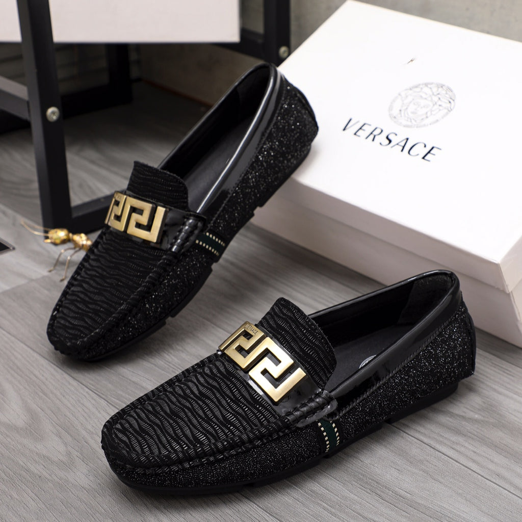 Versace black textured loafers with gold emblem buckle and molded dark sole