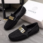 Versace black textured loafers with gold emblem buckle and molded dark sole