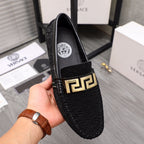 Versace black textured slip-on loafers with gold buckle and round crest badge
