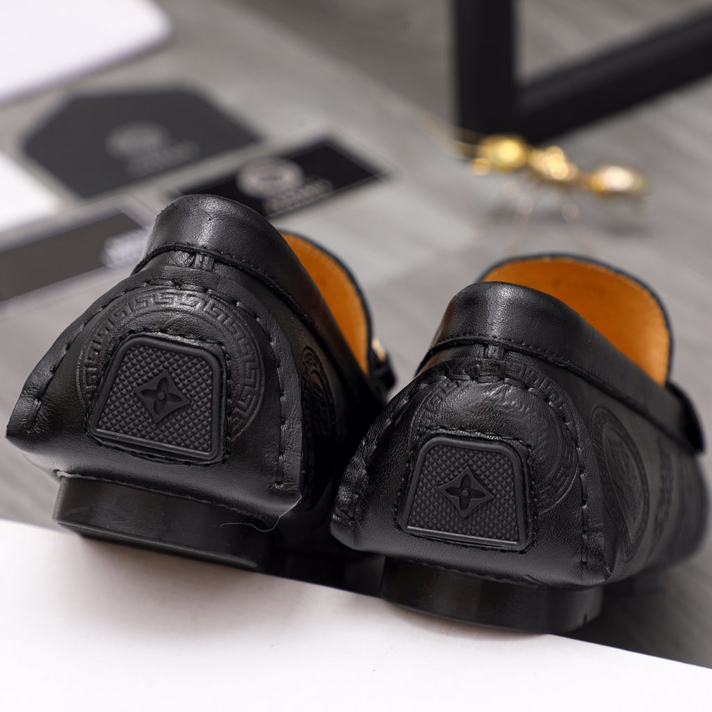 Black Versace leather loafer outsole and heel, textured tread and embossed panels
