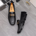 Black Versace leather loafers set, showing gold-tone buckle and embossed logos