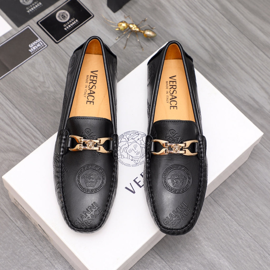 Versace leather loafers in black with gold-tone buckle and embossed medallion