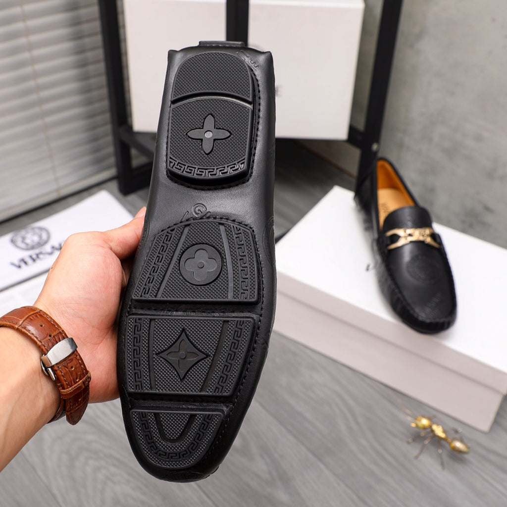 Black Versace leather loafer heel view with embossed geometric logo pattern
