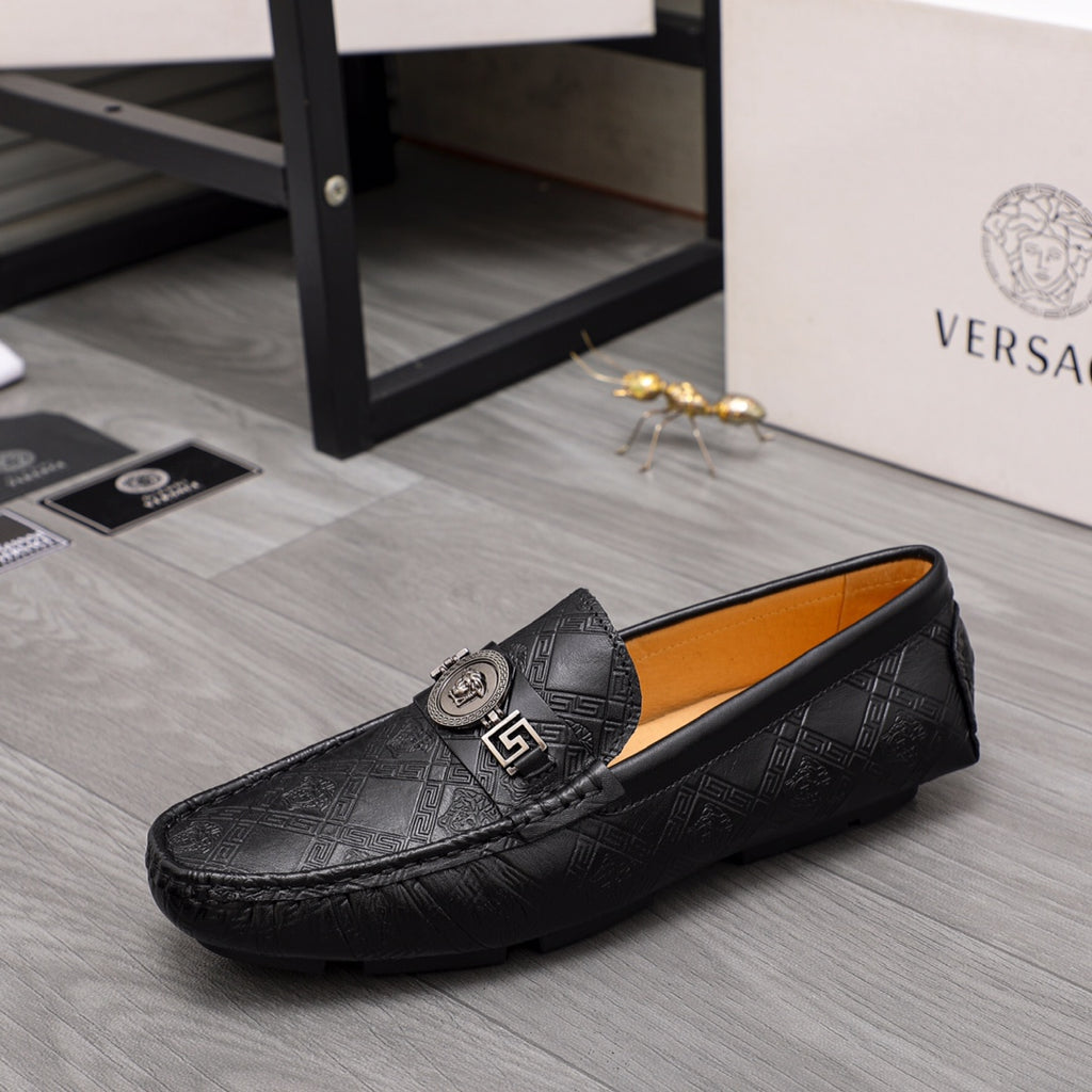 Black patterned leather loafer with gold buckle and embossed logo trim