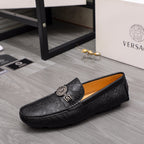 Black patterned leather loafer with gold buckle and embossed logo trim