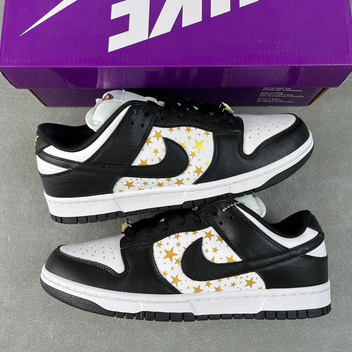 Black and white low-top sneakers with gold star paneling and black rubber sole