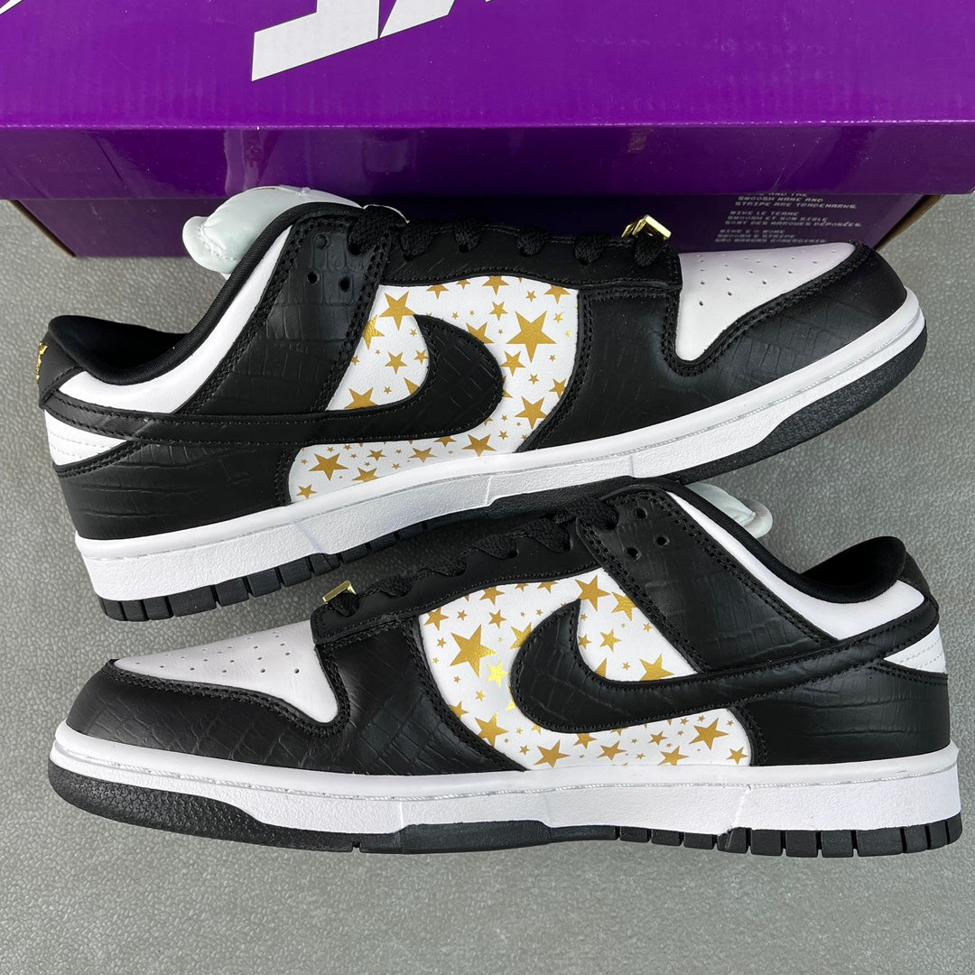 Black and white low-top sneakers with gold star print Swoosh and padded collar