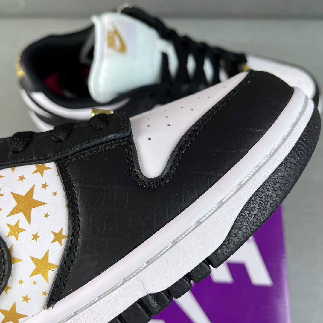 Black leather low-top sneaker with white collar and gold star logo panel